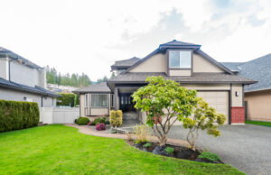 A modern suburban home with a well-maintained lawn and landscaping, representing the importance of curb appeal when preparing for a refinance appraisal.