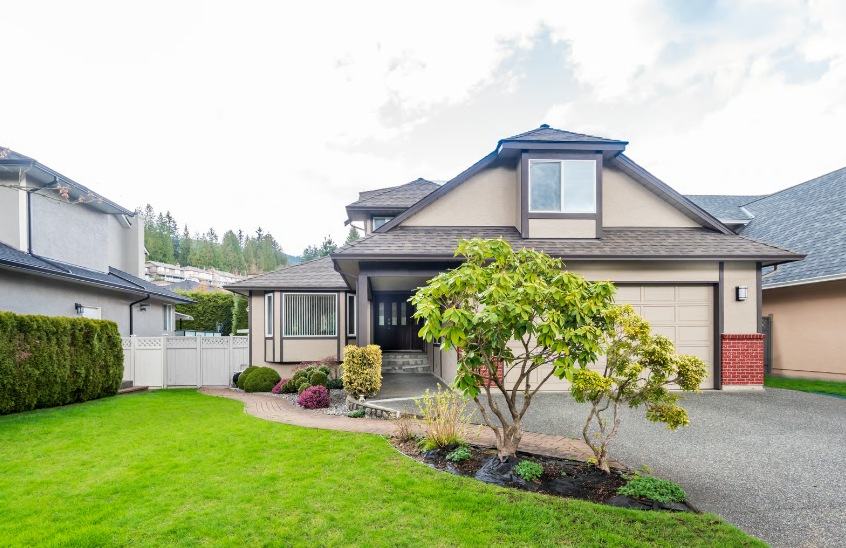 A modern suburban home with a well-maintained lawn and landscaping, representing the importance of curb appeal when preparing for a refinance appraisal.
